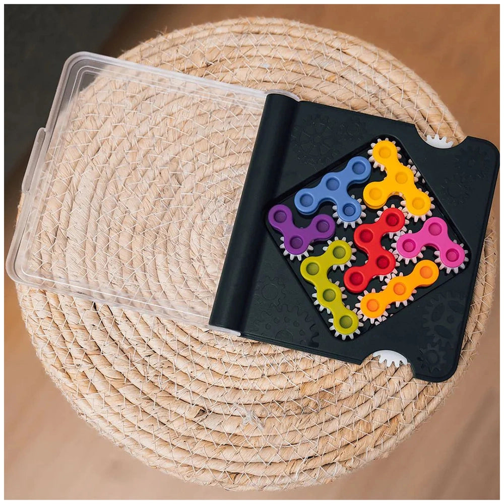 Smart Games IQ Gears container holds colorful gears in a clear lid, placed on a natural fiber mat.