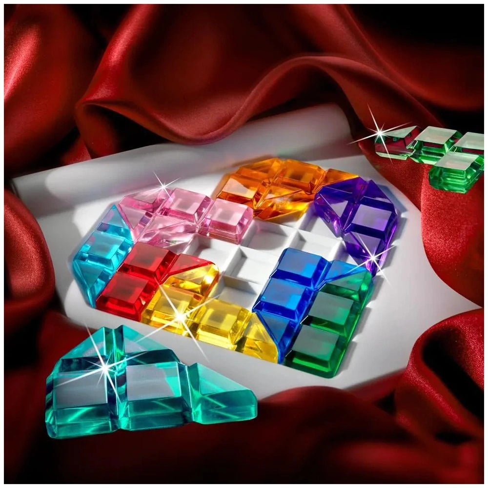 Smart Games - IQ Love showcases colorful, faceted gemstones arranged in a vibrant overlapping pattern on a white surface.