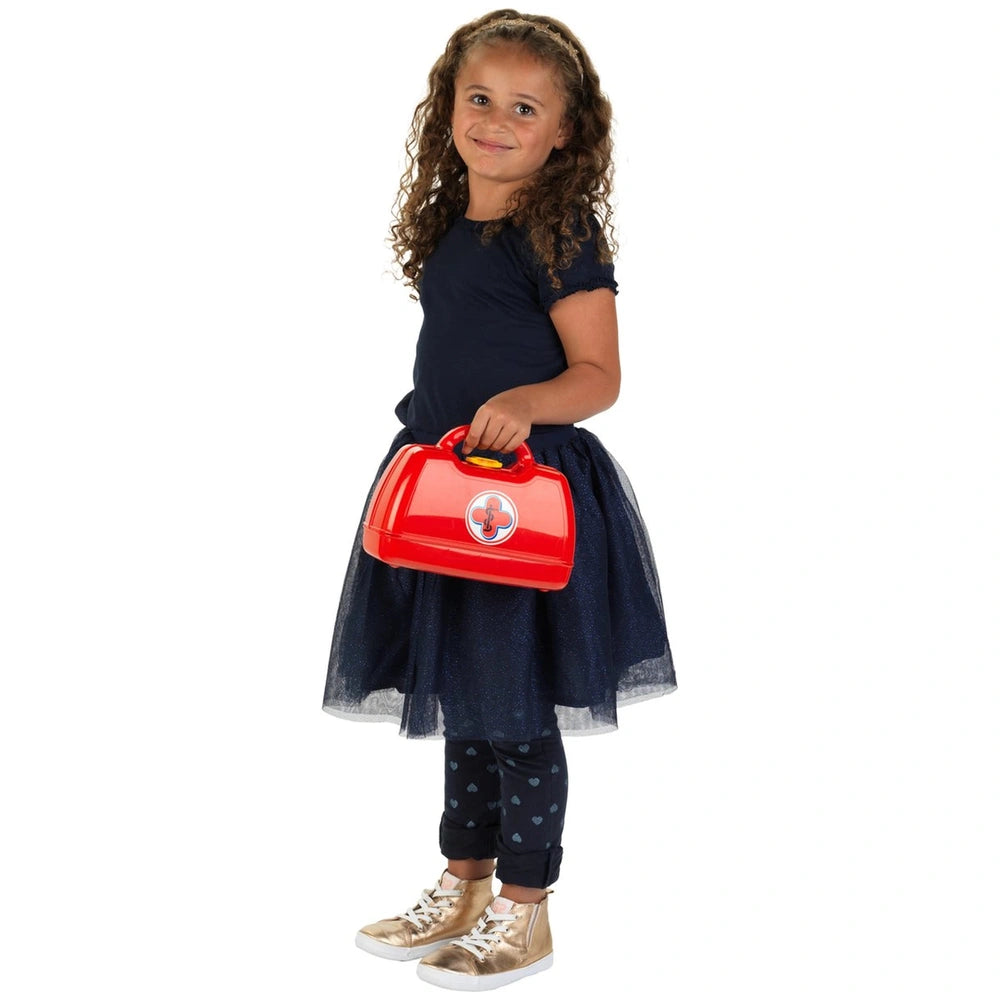 Theo Klein Doctor Case features a smiling girl in a blue dress and black patterned pants holding a red lunchbox with a white 