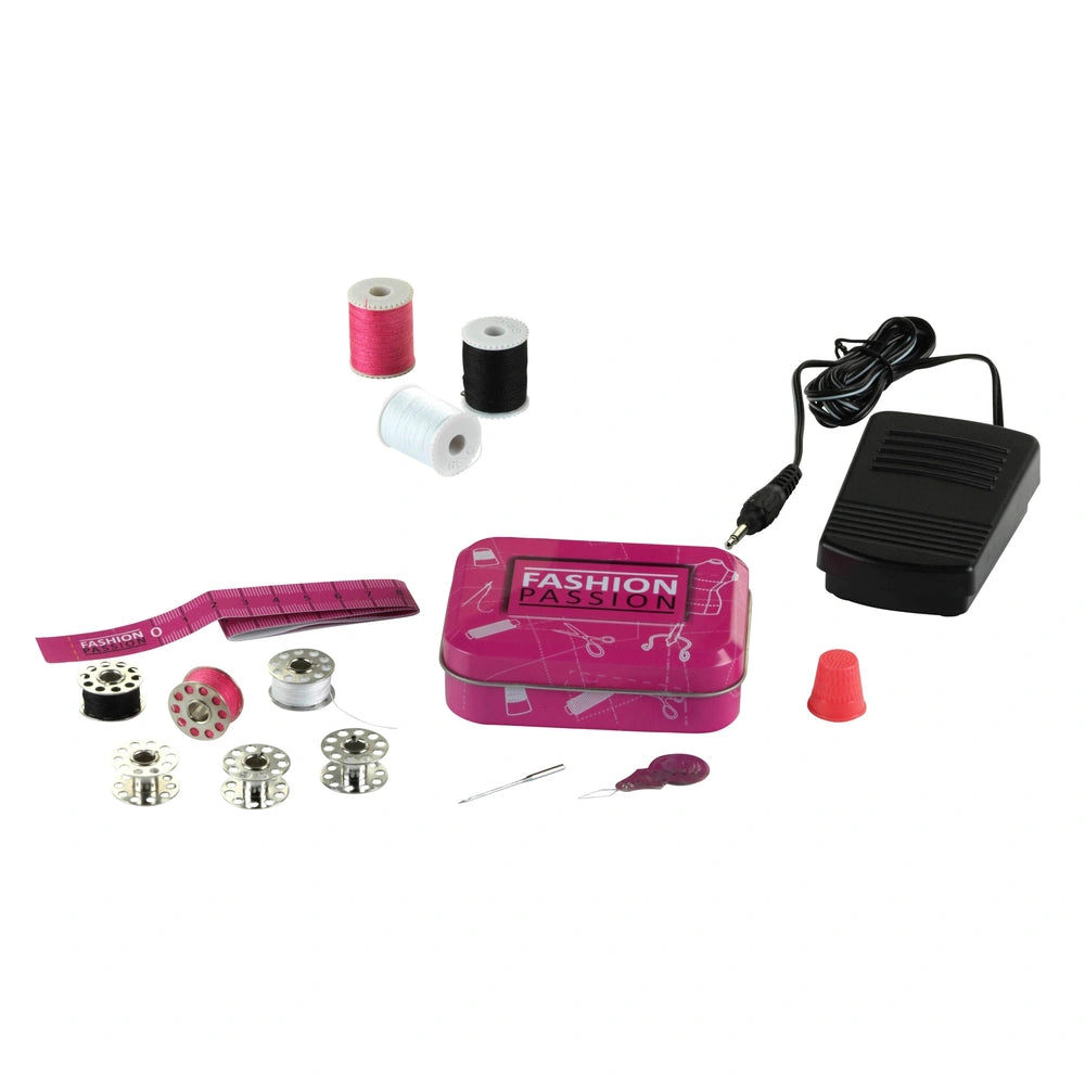 Theo Klein Kids Sewing Machine in glossy pink box with white spools, silver needles, and black cord labeled "NOTIONS".