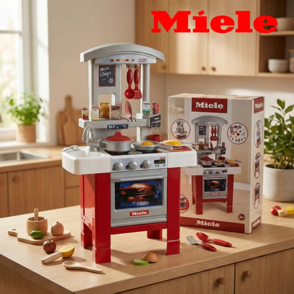 Theo Klein Miele kitchen starter set featuring red and white toy kitchen, silver oven, and colorful plastic fruits on a woode